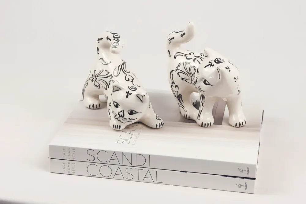 Two patterned ceramic cat figures