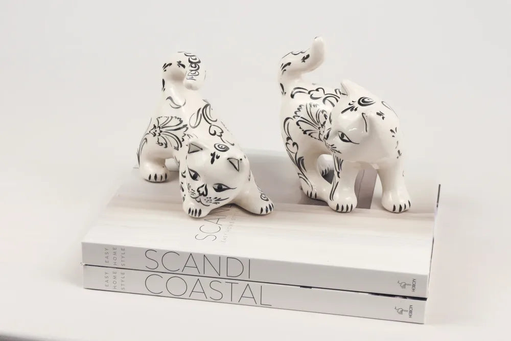 Two decorative ceramic cat figures