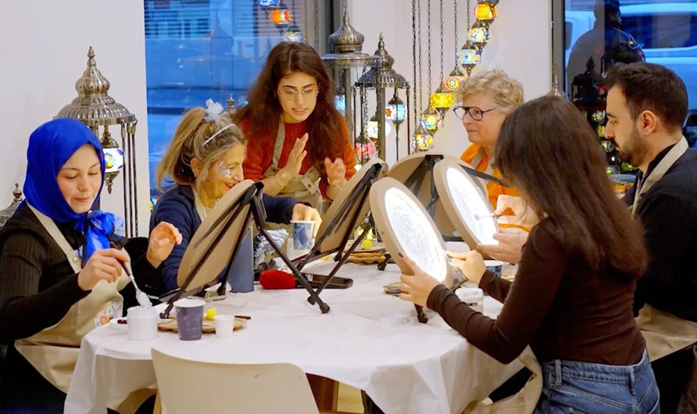 Guests making textured moonlight artworks at the studio